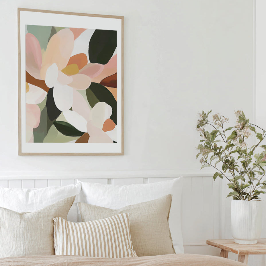 Living room with a floral painting on the wall, white sofa, and plant.
